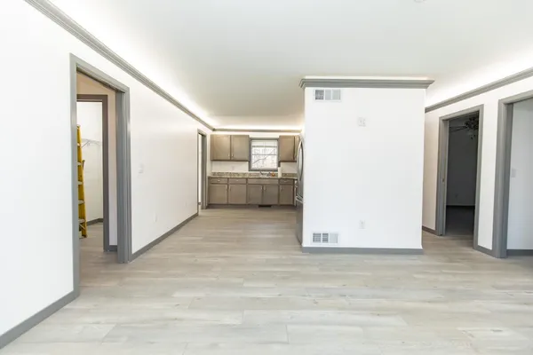 a view of a storage & utility room with refrigerator
