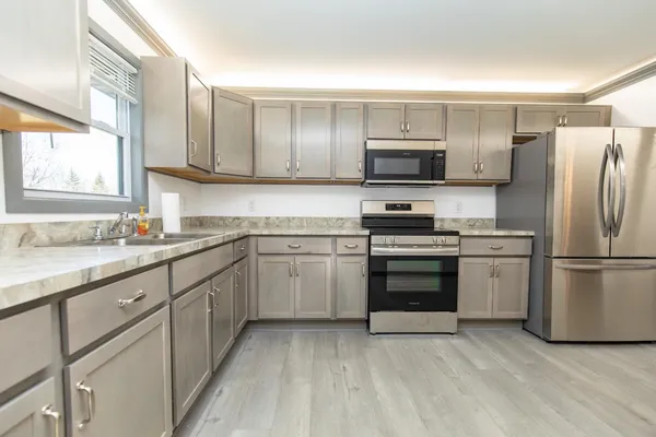 a kitchen with a sink stove and refrigerator