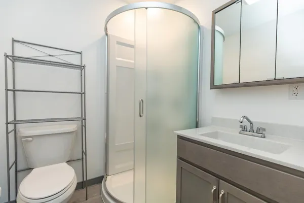 a bathroom with a sink a toilet and a mirror