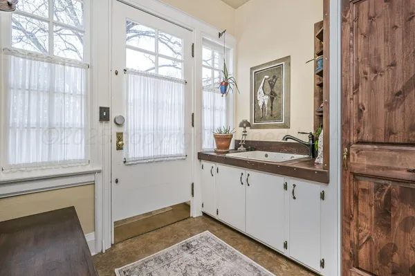 a living room with furniture a fireplace and a chandelier