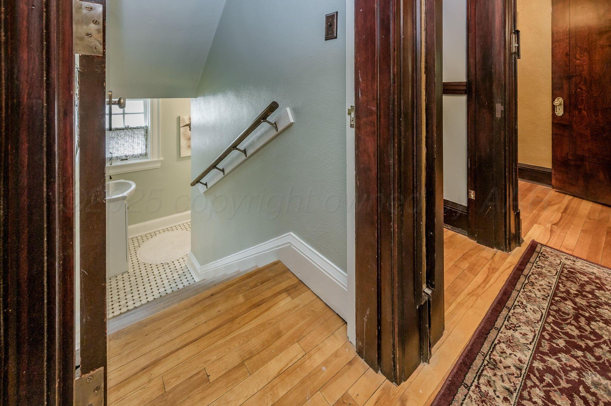 1620 South Tyler Street Amarillo, TX 79102 - Photo 21 of 66 a view of a hallway with wooden floor and staircase