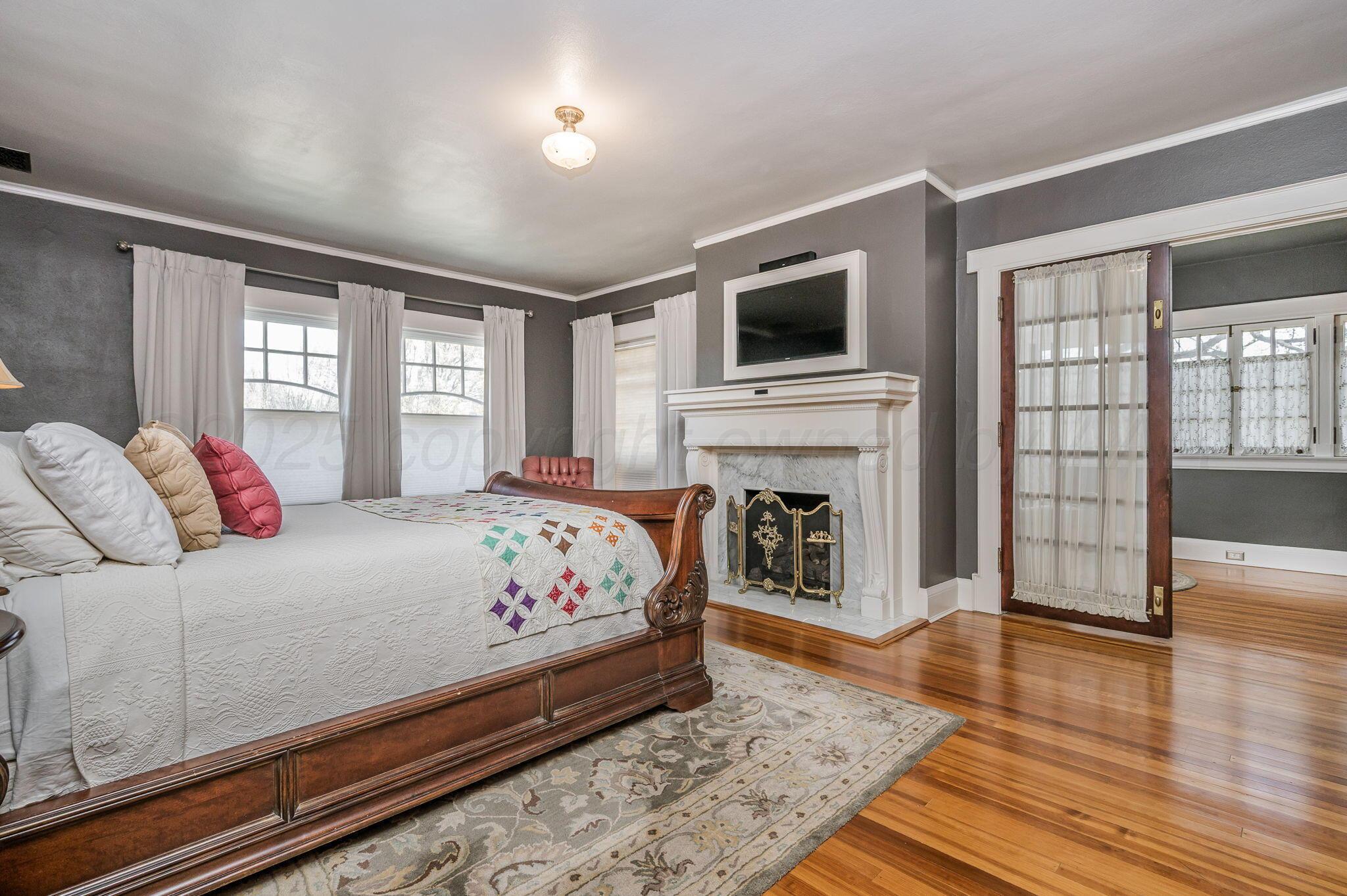 1620 South Tyler Street Amarillo, TX 79102 - Photo 28 of 66 a bedroom with a bed and a flat screen tv