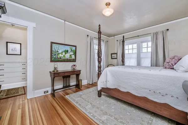 a living room with furniture a piano and wooden floor