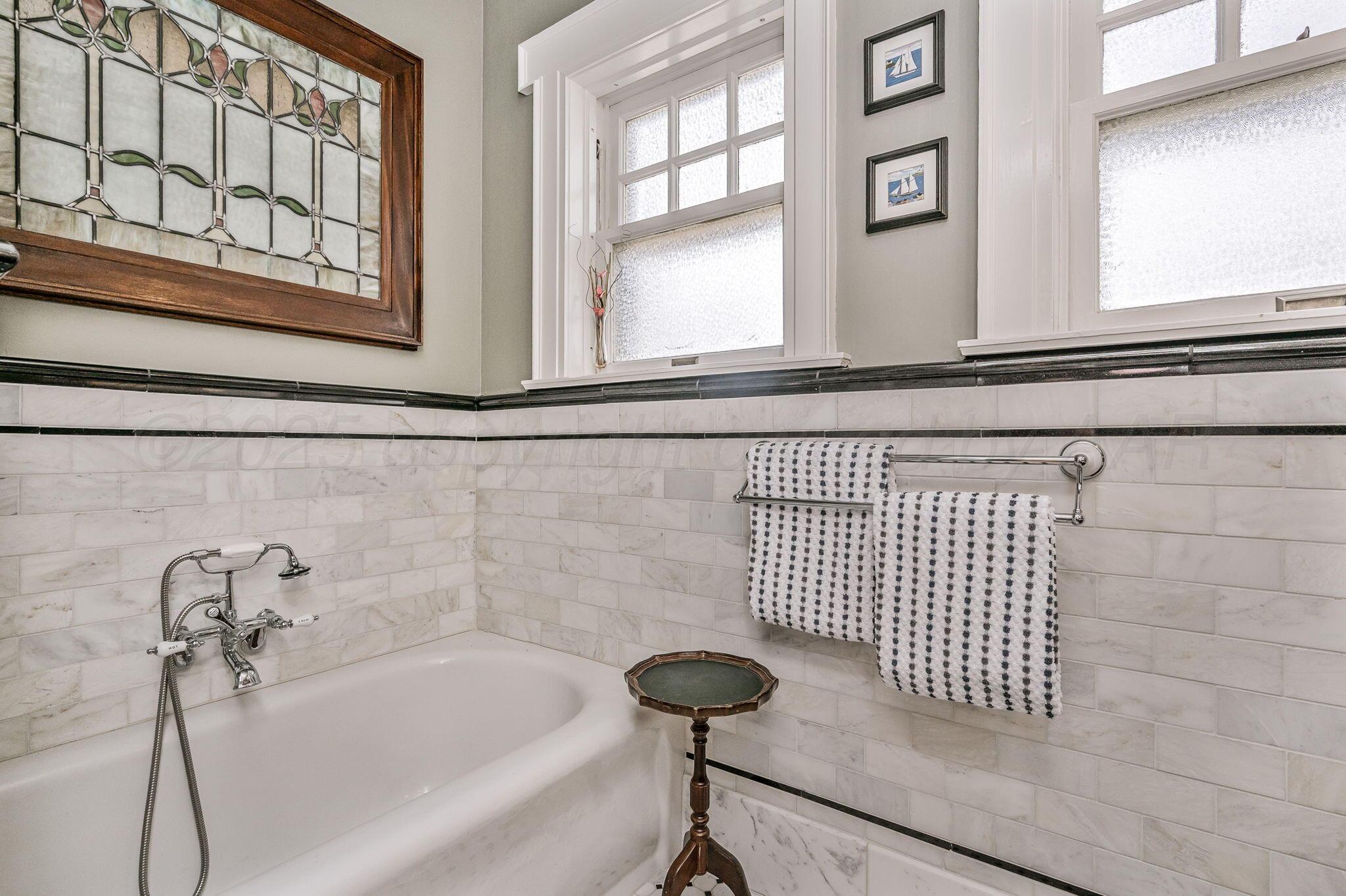 1620 South Tyler Street Amarillo, TX 79102 - Photo 40 of 66 a bathroom with a bathtub and a window