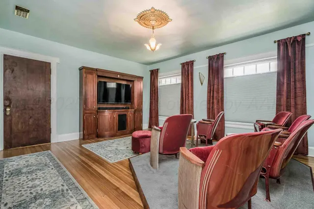 a kitchen with stainless steel appliances granite countertop a sink a stove and a wooden floors