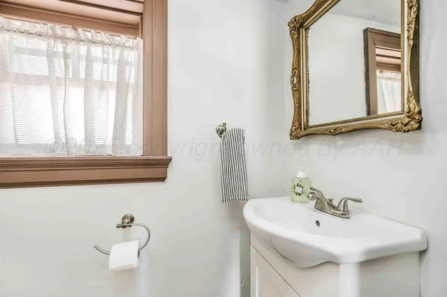 a view of a house with a big yard and large trees