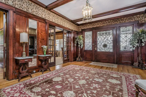a living room with furniture a fireplace and lots of windows