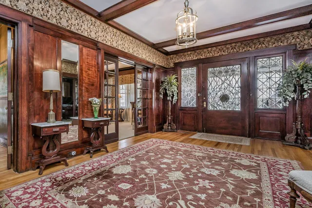 a living room with furniture a fireplace and lots of windows