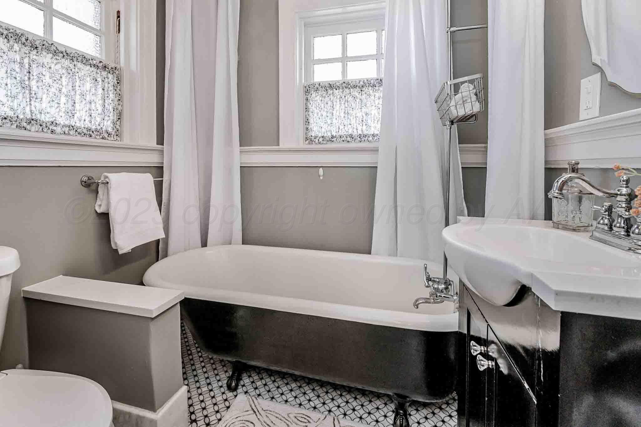 1620 South Tyler Street Amarillo, TX 79102 - Photo 61 of 66 a bathroom with a sink a toilet and a window