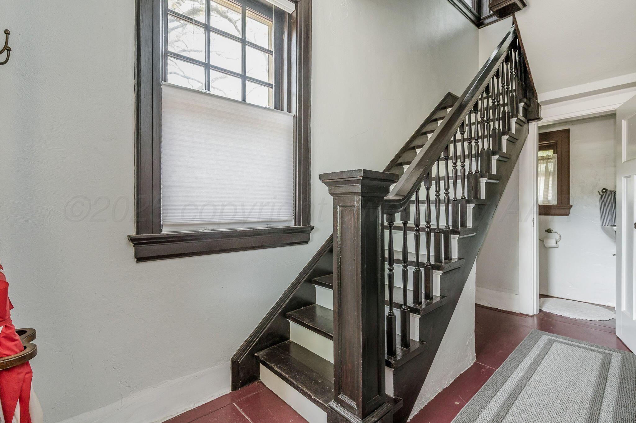 1620 South Tyler Street Amarillo, TX 79102 - Photo 63 of 66 a view of staircase with wooden floor and a front door