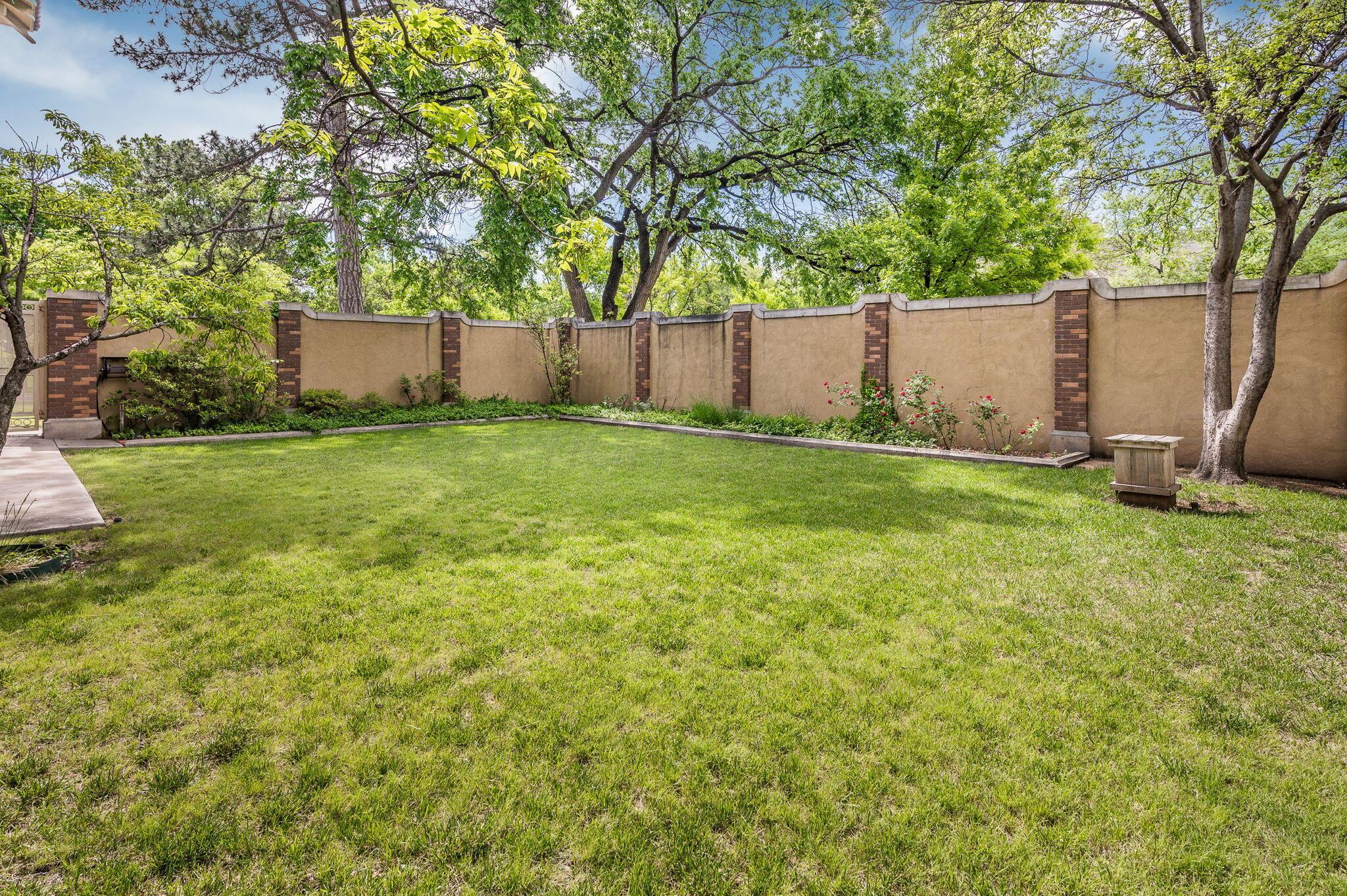 1620 South Tyler Street Amarillo, TX 79102 - Photo 66 of 66 a view of a backyard with large trees and wooden fence
