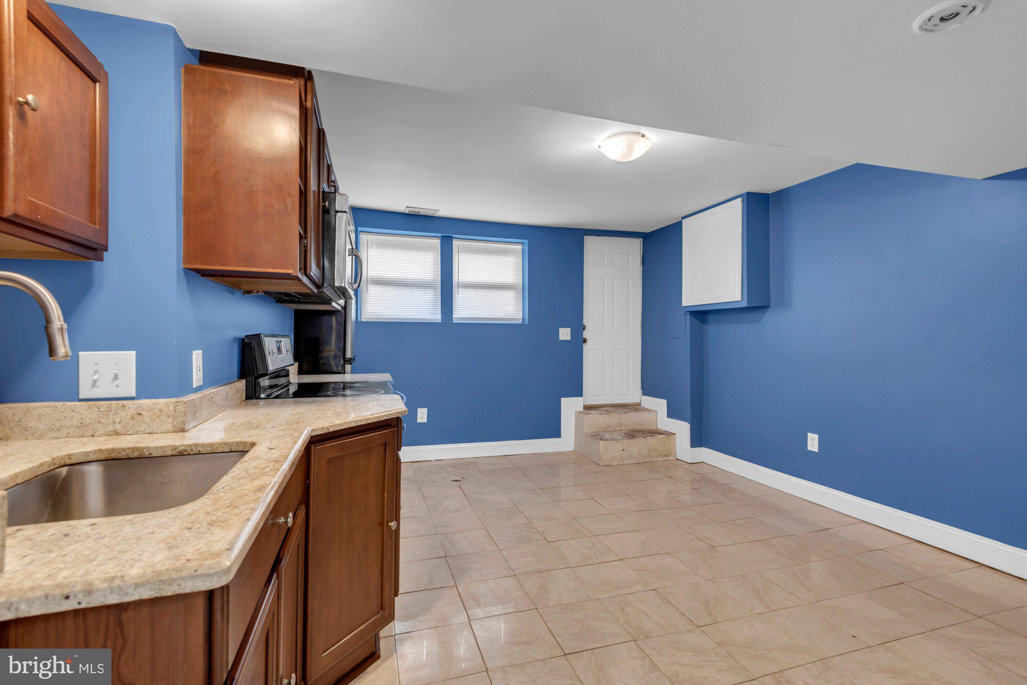 210 West Read Street Baltimore, MD 21201 - Photo 25 of 26 a kitchen with a sink cabinets and a kitchen island
