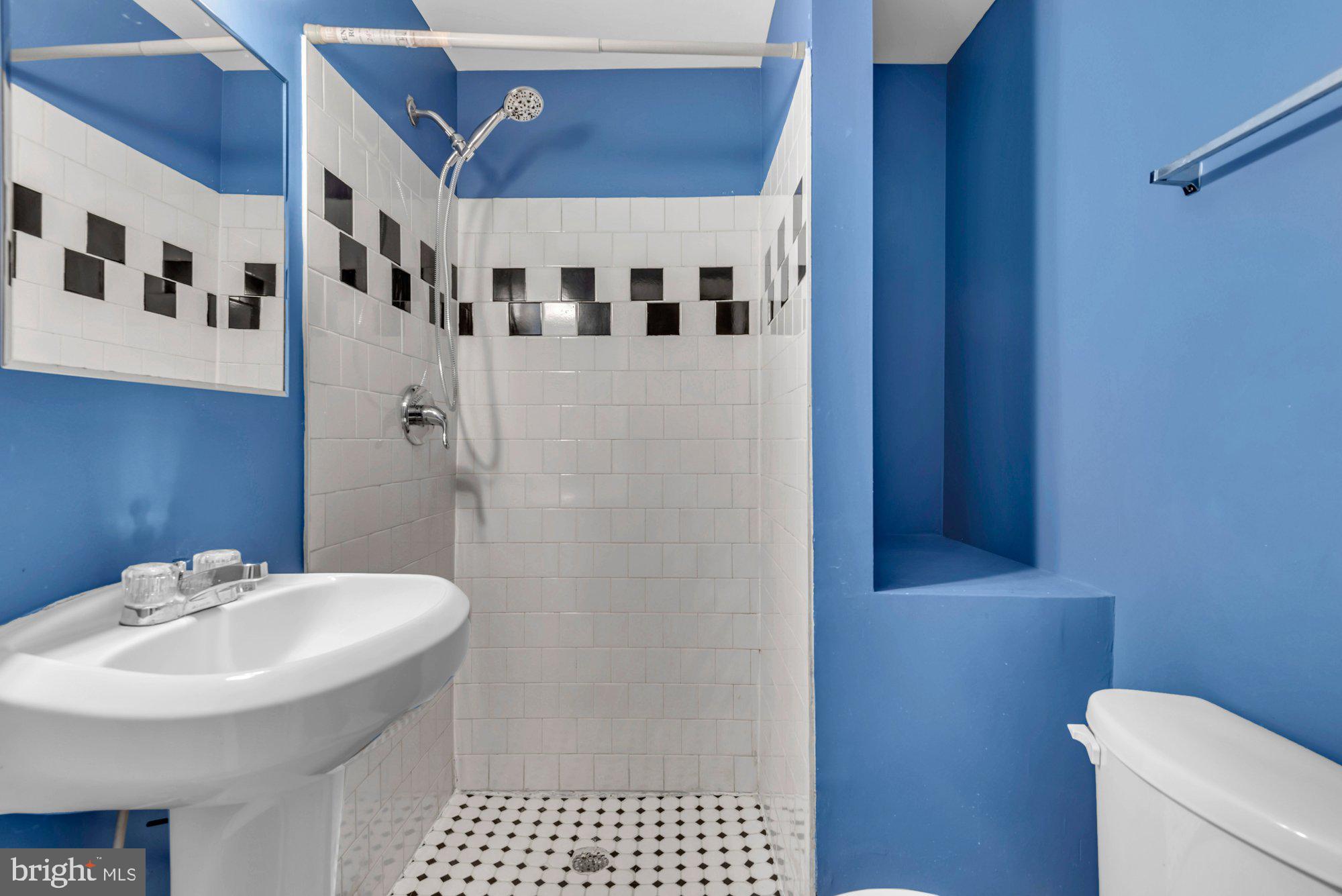 210 West Read Street Baltimore, MD 21201 - Photo 26 of 26 a bathroom with a sink a toilet and shower