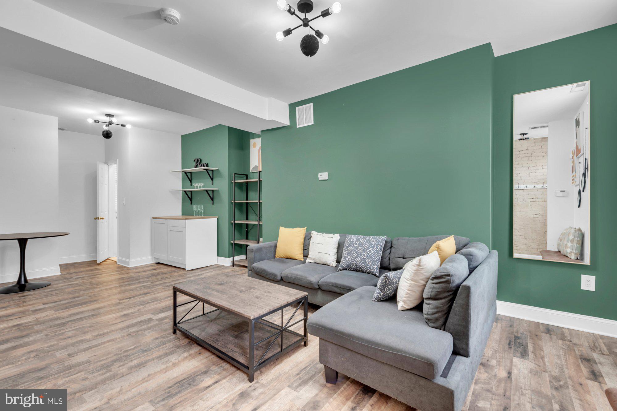 210 West Read Street Baltimore, MD 21201 - Photo 5 of 26 a living room with furniture and a wooden floor