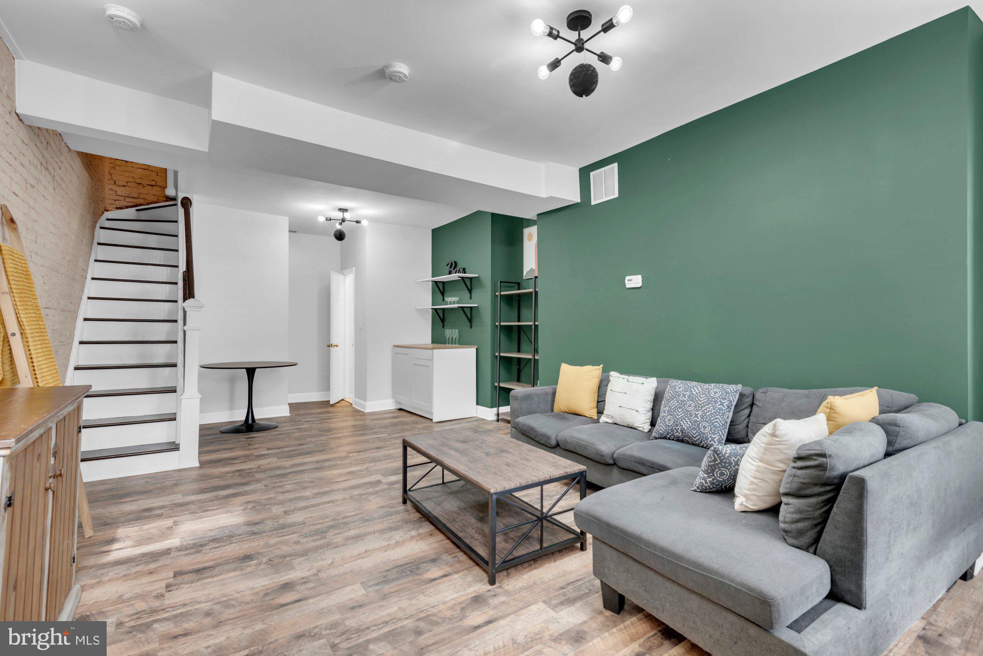 210 West Read Street Baltimore, MD 21201 - Photo 7 of 26 a living room with furniture and a chandelier