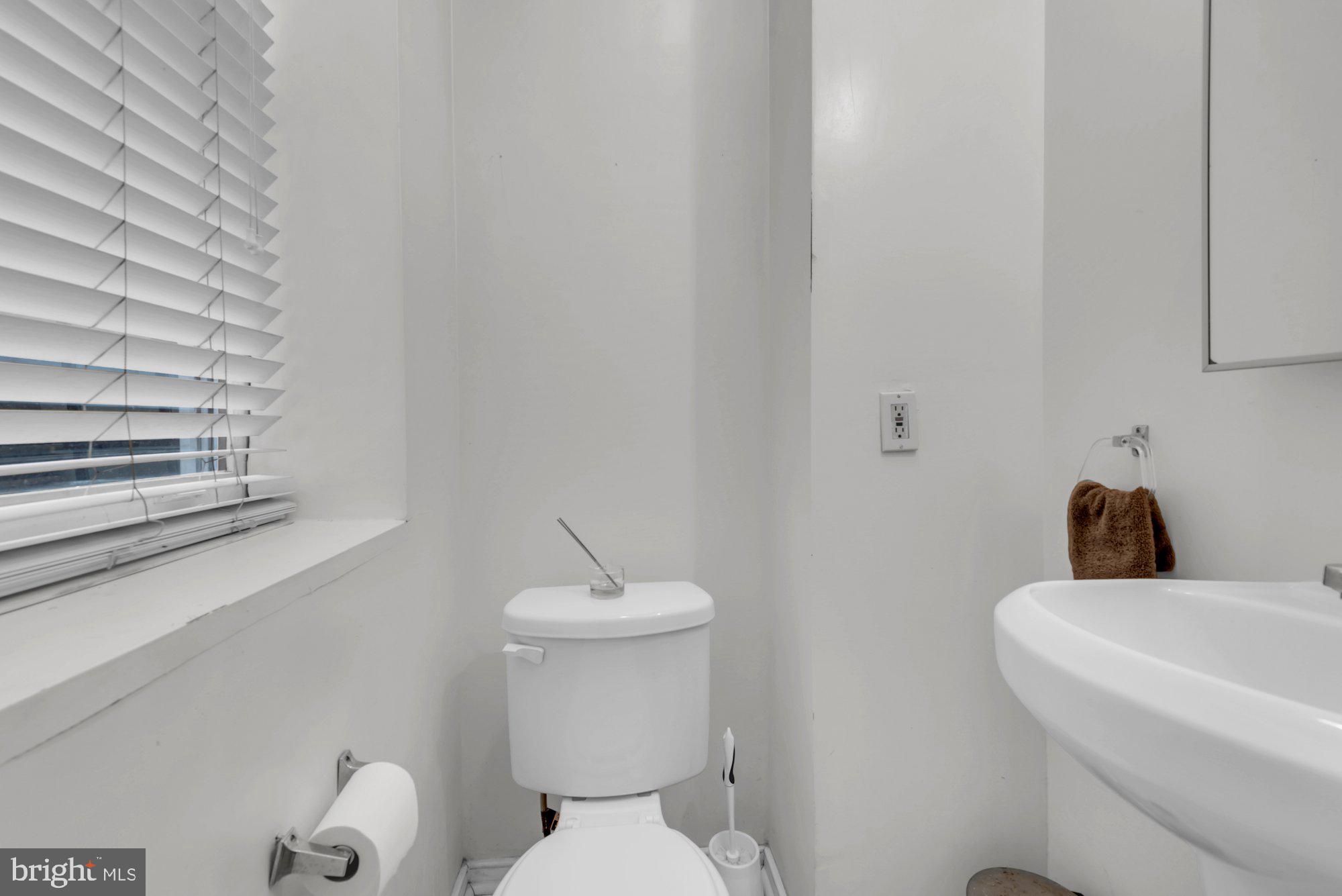 210 West Read Street Baltimore, MD 21201 - Photo 10 of 26 a white toilet sitting next to a bathroom sink