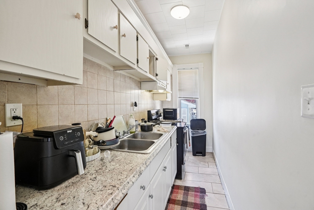 50 Whipple Street Worcester, MA 01607 - Photo 21 of 30 a kitchen with a sink and cabinets