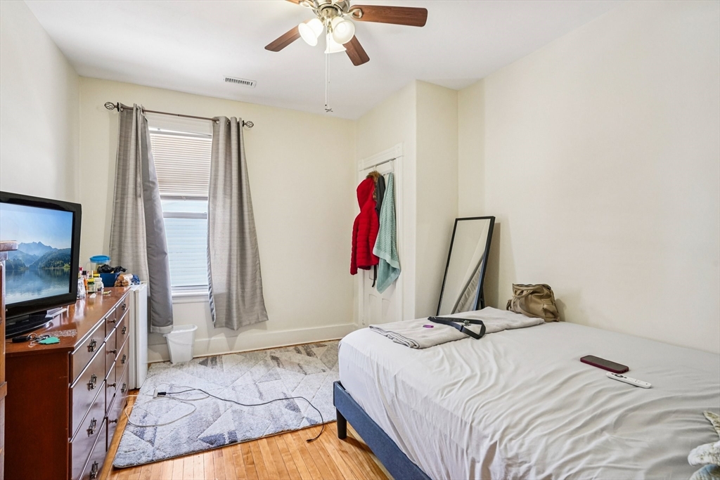 50 Whipple Street Worcester, MA 01607 - Photo 23 of 30 a bedroom with a bed and a flat screen tv