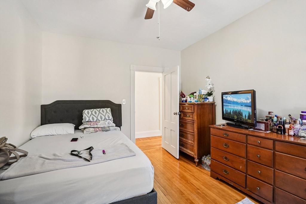 50 Whipple Street Worcester, MA 01607 - Photo 24 of 30 a bedroom with a bed and wooden floor
