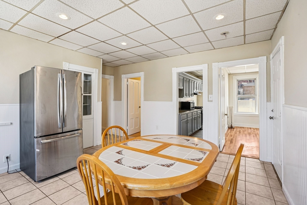 50 Whipple Street Worcester, MA 01607 - Photo 9 of 30 a large kitchen with a table and refrigerator