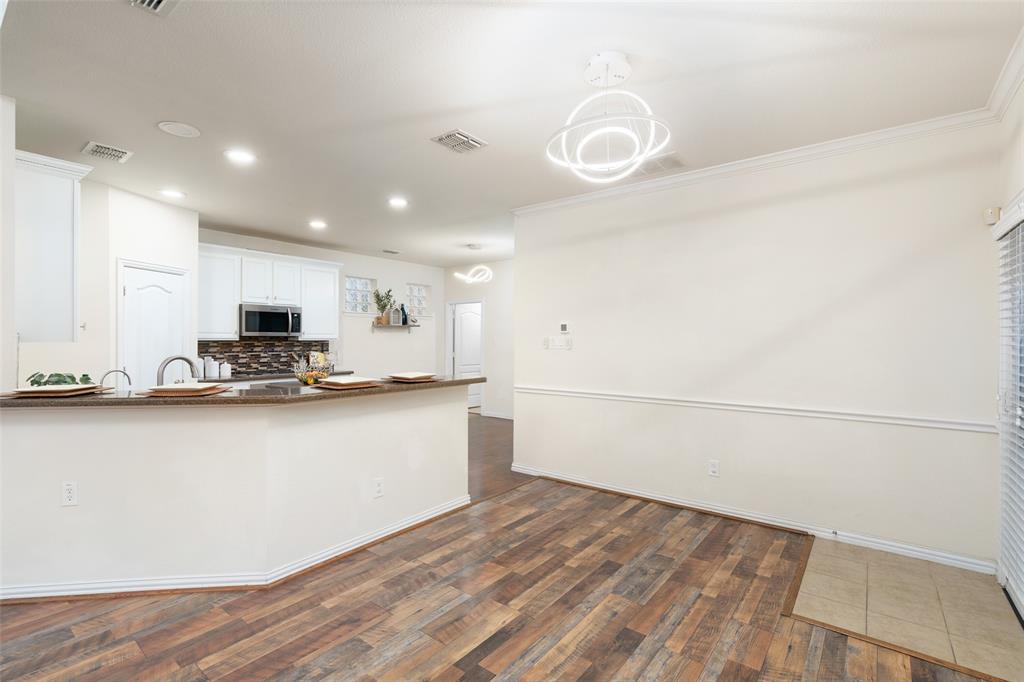 7113 Occidental Road Plano, TX 75025 - Photo 11 of 35 a view of a kitchen with microwave and stove