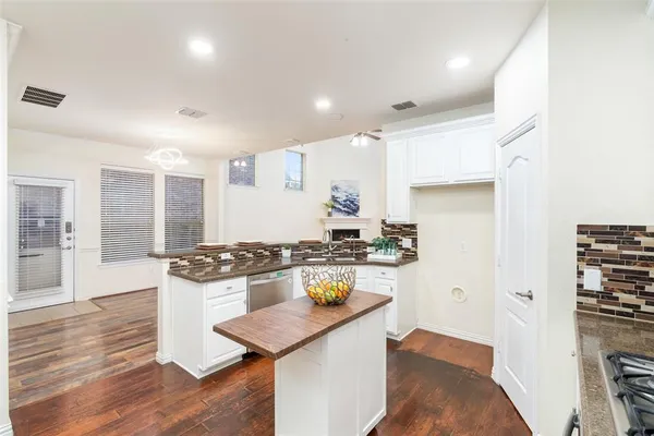 a kitchen with stainless steel appliances granite countertop a stove and a refrigerator
