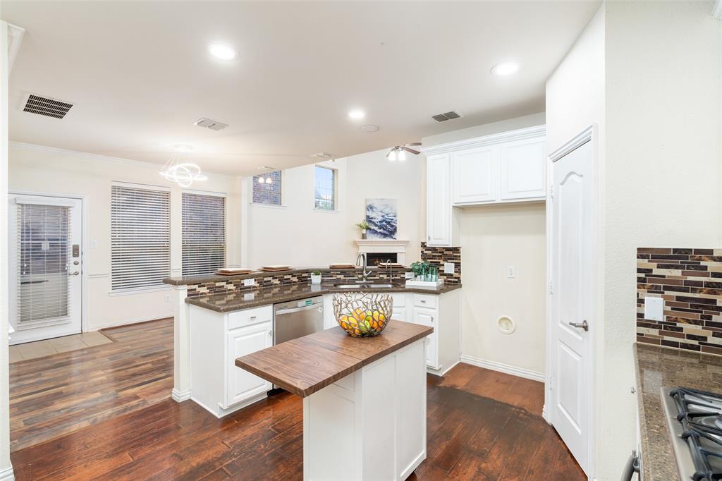 7113 Occidental Road Plano, TX 75025 - Photo 15 of 35 a kitchen with stainless steel appliances granite countertop a stove and a refrigerator