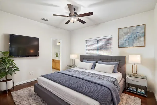 a bedroom with a large bed and a flat screen tv