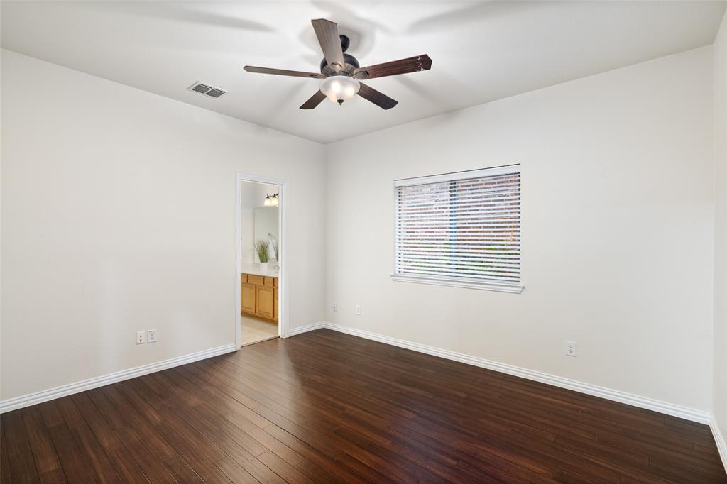7113 Occidental Road Plano, TX 75025 - Photo 17 of 35 wooden floor in an empty room with a window