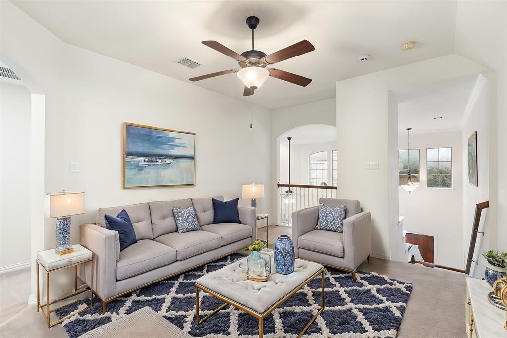 7113 Occidental Road Plano, TX 75025 - Photo 19 of 35 a living room with furniture a rug and a chandelier