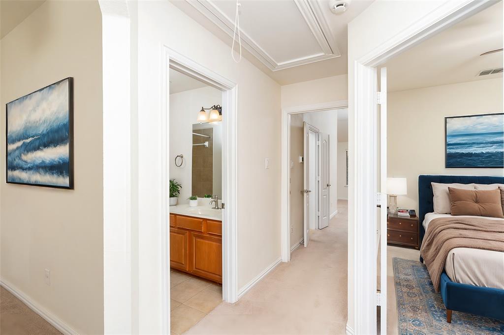 7113 Occidental Road Plano, TX 75025 - Photo 22 of 35 a bedroom with furniture and a hallway