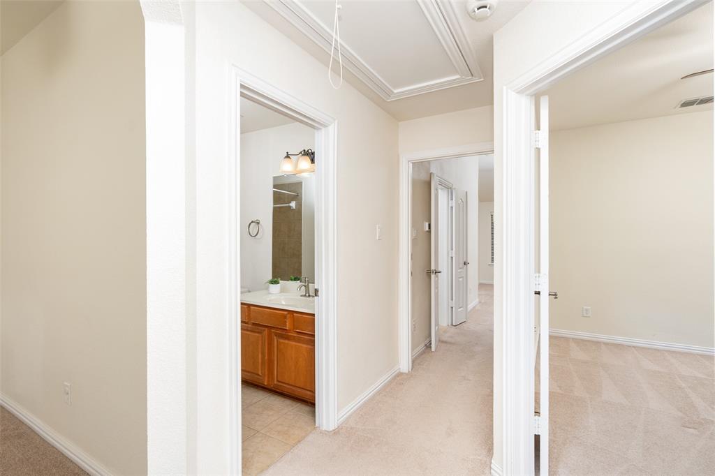 7113 Occidental Road Plano, TX 75025 - Photo 23 of 35 a view of a bathroom from a hallway
