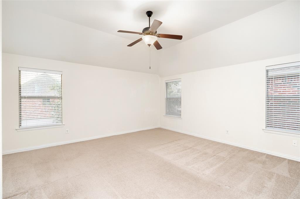 7113 Occidental Road Plano, TX 75025 - Photo 25 of 35 an empty room with a window and a fan