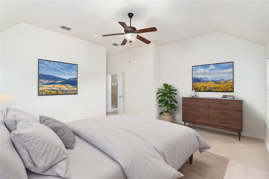 7113 Occidental Road Plano, TX 75025 - Photo 26 of 35 a bedroom with a bed and a chandelier