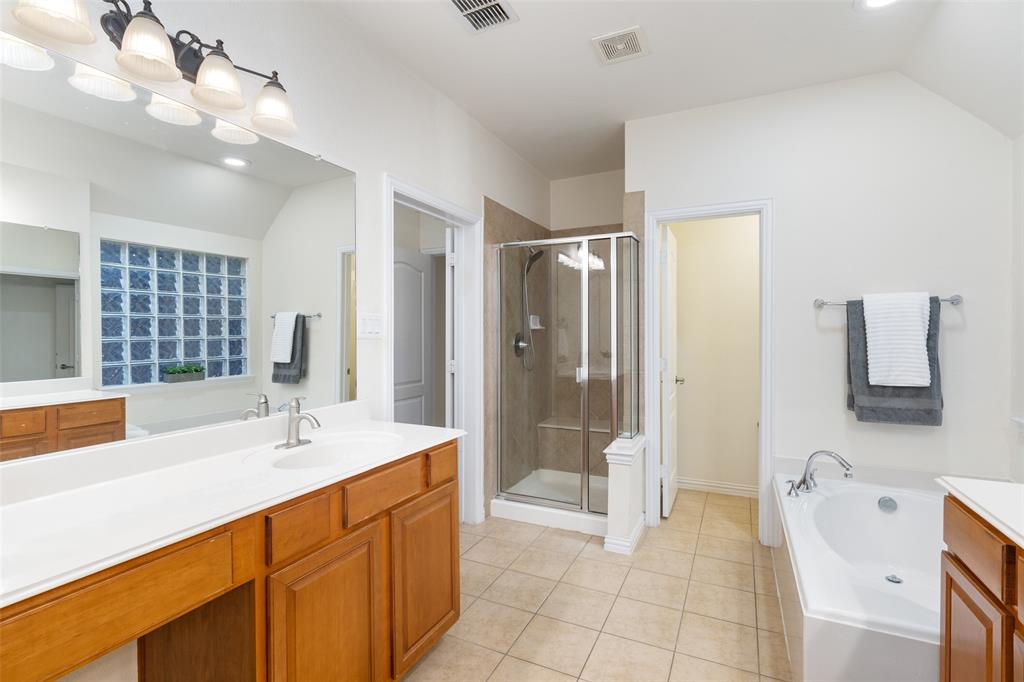 7113 Occidental Road Plano, TX 75025 - Photo 29 of 35 a spacious bathroom with a double vanity sink mirror and shower