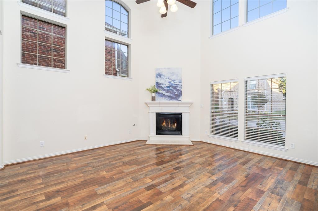 7113 Occidental Road Plano, TX 75025 - Photo 5 of 35 a view of an empty room with wooden floor and a window