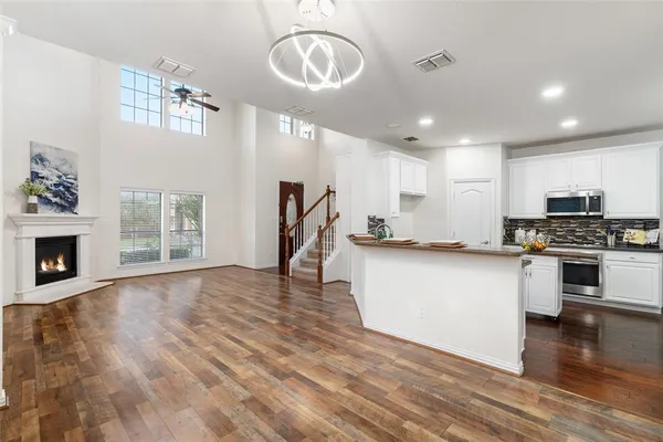 a view of kitchen with sink microwave and stove