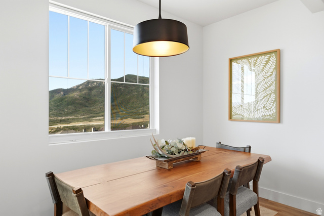6039 North Westridge Road Heber City, UT 84032 - Photo 14 of 71 Large white-framed window, mountain scenery, black drum pendant light, and wood-finish flooring