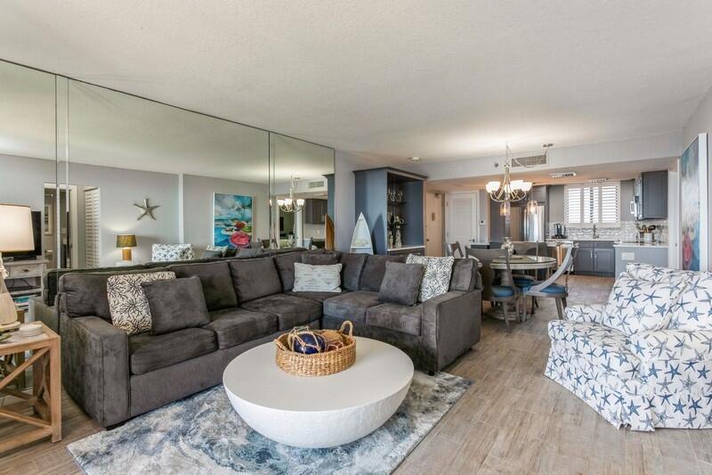 100 Ocean Trail Way, Unit 1010 Jupiter, FL 33477 - Photo 11 of 40 a living room with furniture and a dining table with kitchen view