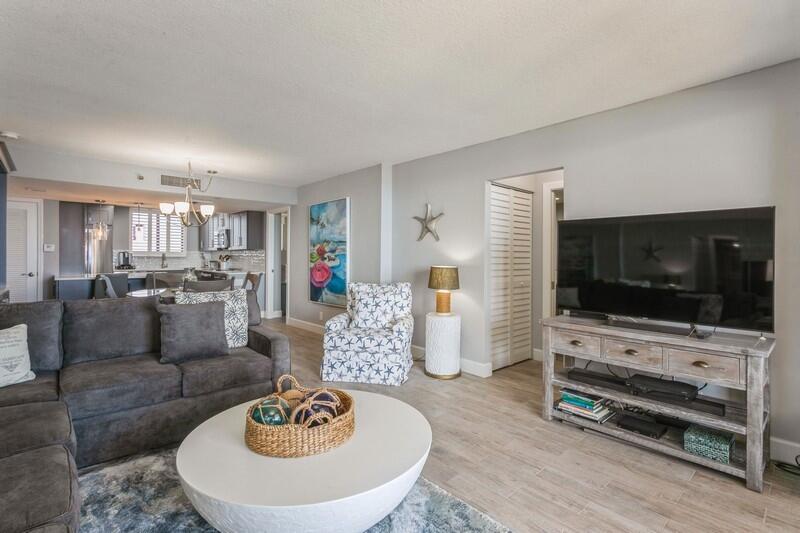 100 Ocean Trail Way, Unit 1010 Jupiter, FL 33477 - Photo 12 of 40 a living room with furniture and a flat screen tv