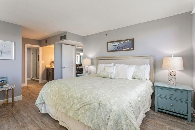 100 Ocean Trail Way, Unit 1010 Jupiter, FL 33477 - Photo 13 of 40 a bedroom with a bed and a lamp on dresser