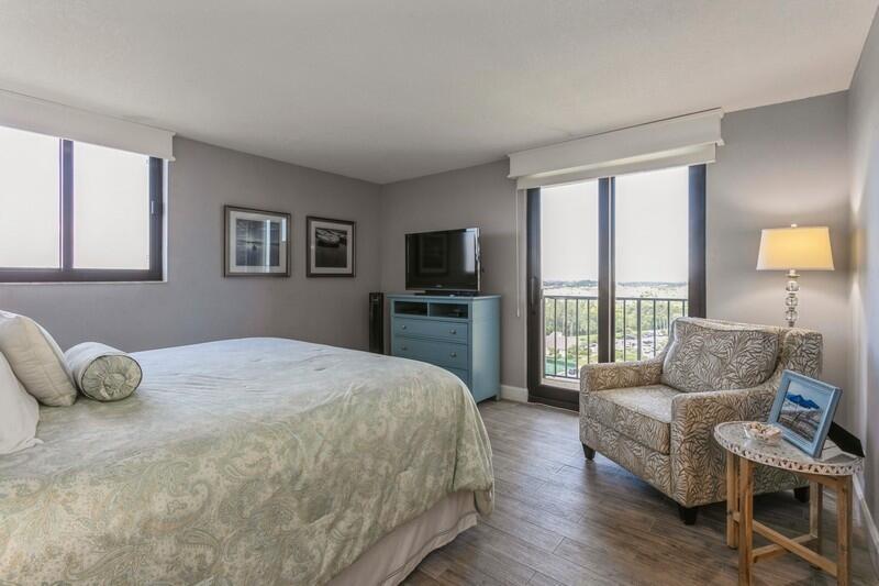 100 Ocean Trail Way, Unit 1010 Jupiter, FL 33477 - Photo 14 of 40 a bedroom with a bed and wooden floor
