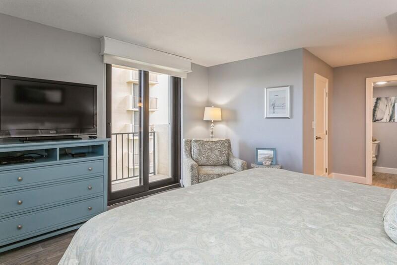 100 Ocean Trail Way, Unit 1010 Jupiter, FL 33477 - Photo 15 of 40 a bedroom with a bed and a flat screen tv