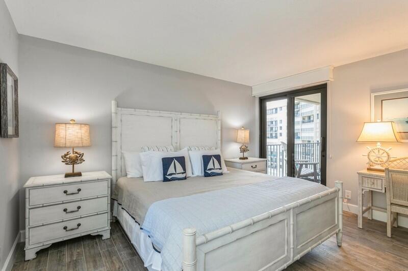 100 Ocean Trail Way, Unit 1010 Jupiter, FL 33477 - Photo 19 of 40 a bedroom with a bed and a lamp on dresser