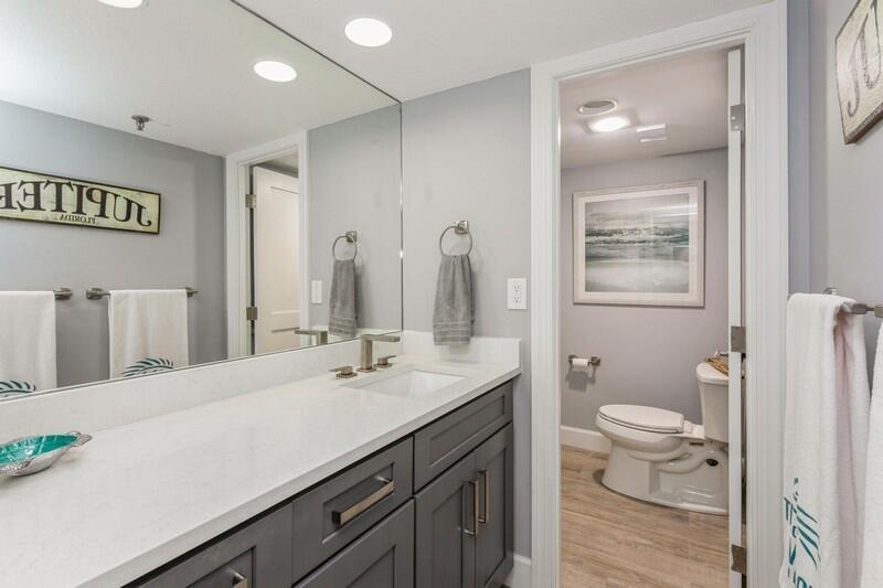 100 Ocean Trail Way, Unit 1010 Jupiter, FL 33477 - Photo 21 of 40 a bathroom with a sink vanity granite and toilet