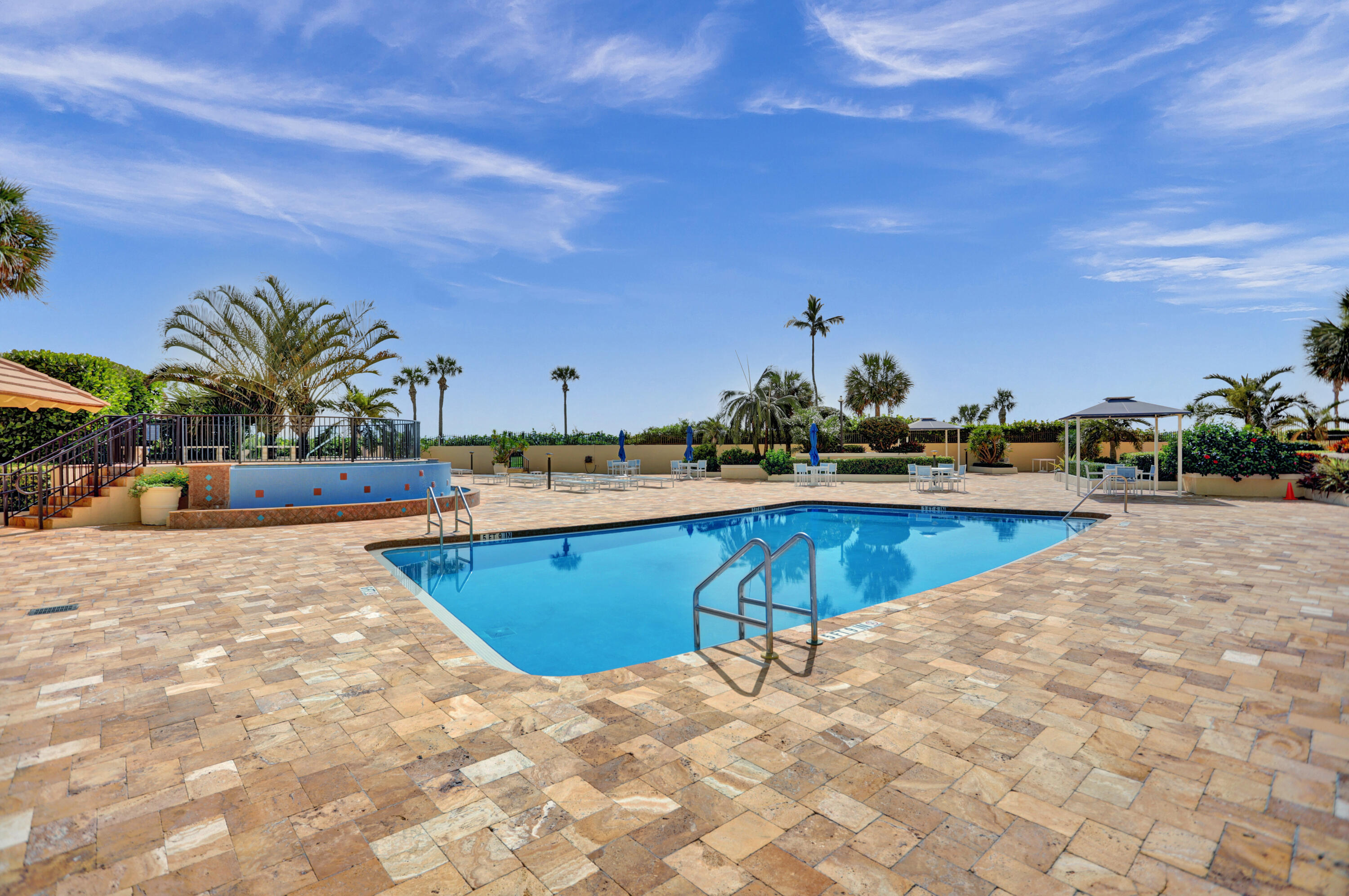 100 Ocean Trail Way, Unit 1010 Jupiter, FL 33477 - Photo 26 of 40 a view of a swimming pool with an outdoor seating