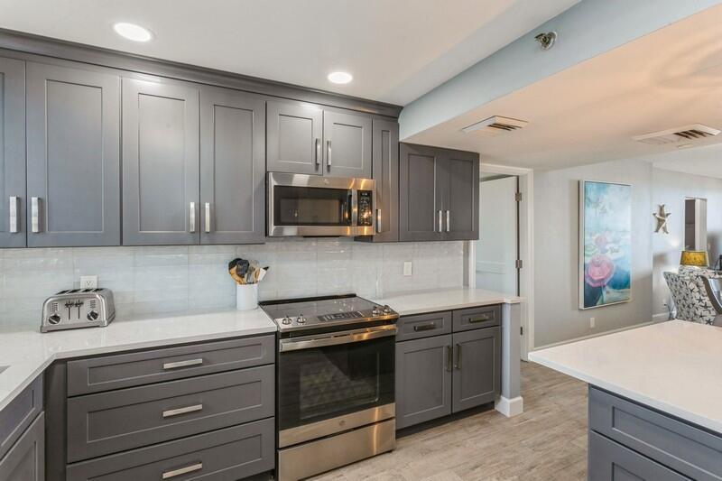 100 Ocean Trail Way, Unit 1010 Jupiter, FL 33477 - Photo 6 of 40 a kitchen with appliances a sink and cabinets
