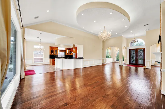 a kitchen with stainless steel appliances granite countertop a sink a stove cabinets counter space and a window
