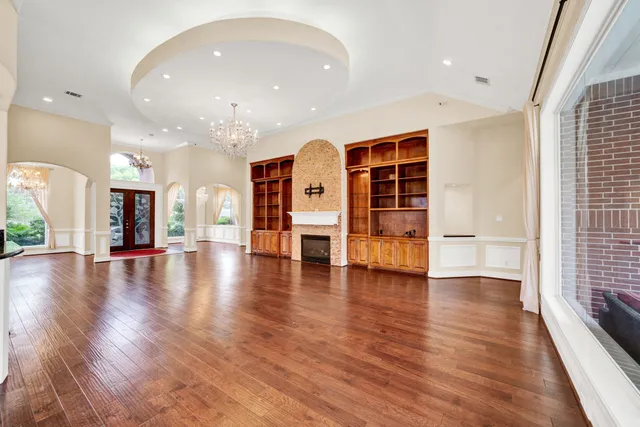 a large kitchen with stainless steel appliances granite countertop wooden cabinets a sink and dishwasher