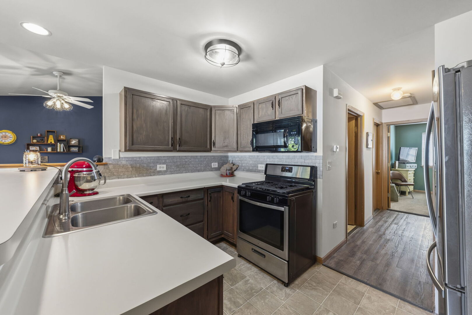 965 Constance Lane, Unit G Sycamore, IL 60178 - Photo 13 of 25 a kitchen that has a sink and a stove in it